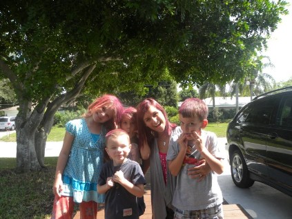 Ava's friends over at my house playing in the yard. At the time, I had temporary purple hair so we sprayed theirs purple to match!